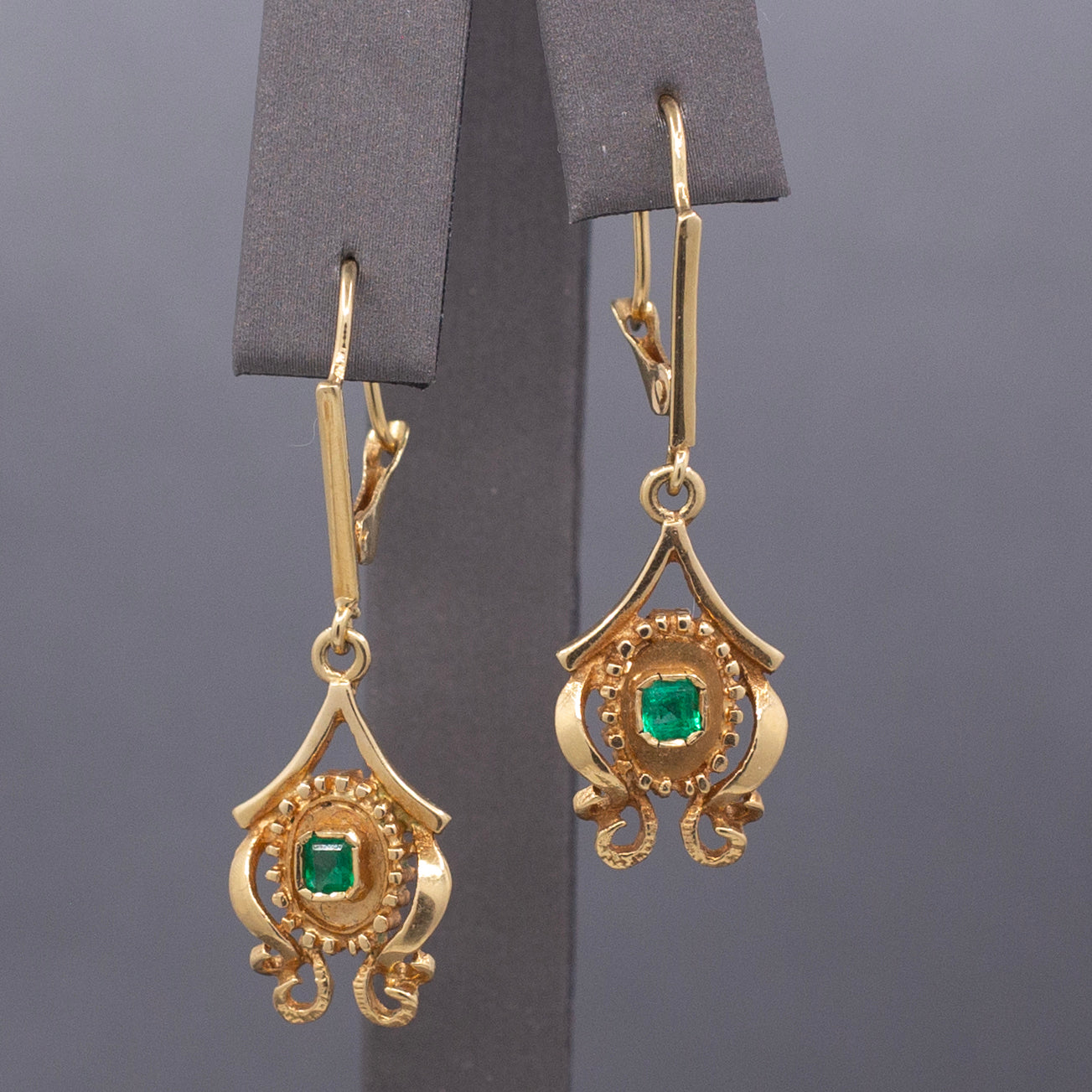Feminine Bezel Set Emerald Dangle Drop Earrings in 18k Yellow Gold