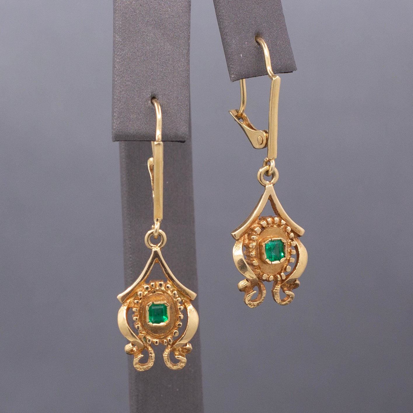 Feminine Bezel Set Emerald Dangle Drop Earrings in 18k Yellow Gold