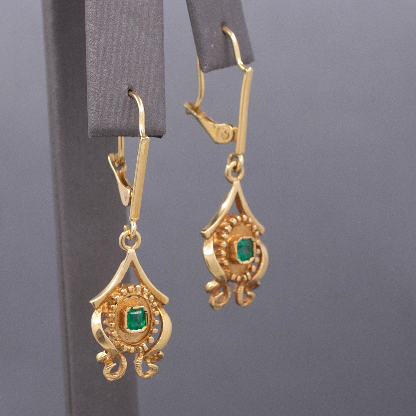 Feminine Bezel Set Emerald Dangle Drop Earrings in 18k Yellow Gold