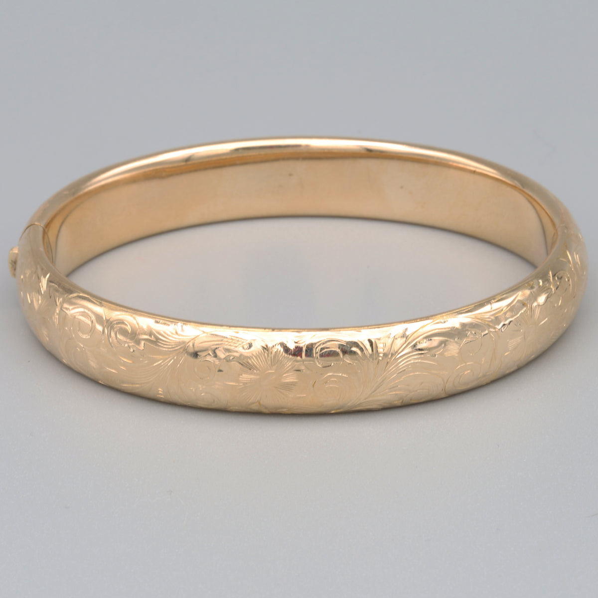 Floral Engraved Domed Oval Hinged Bangle in 14k Yellow Gold