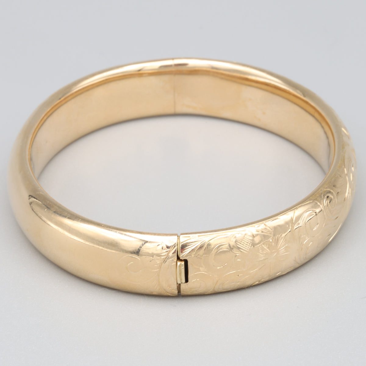 Floral Engraved Domed Oval Hinged Bangle in 14k Yellow Gold