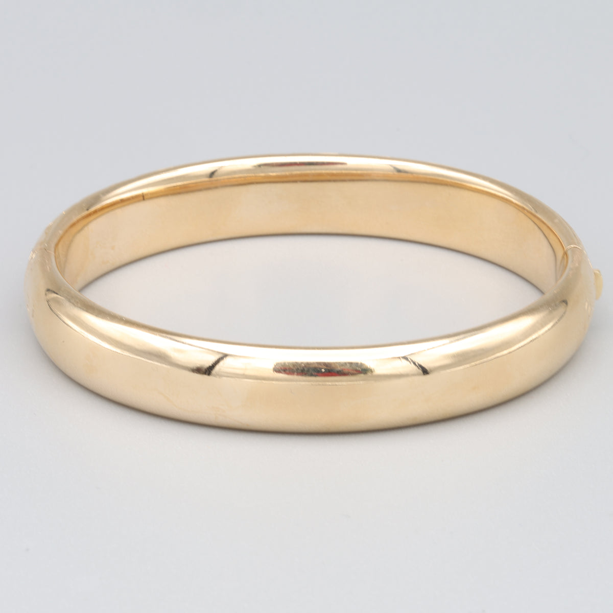 Floral Engraved Domed Oval Hinged Bangle in 14k Yellow Gold