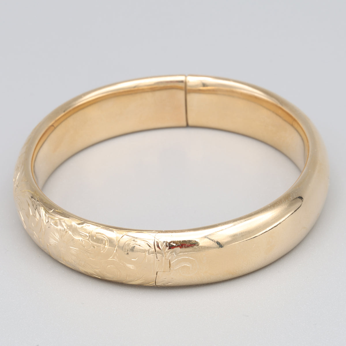 Floral Engraved Domed Oval Hinged Bangle in 14k Yellow Gold