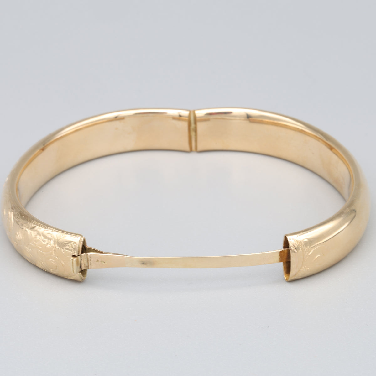 Floral Engraved Domed Oval Hinged Bangle in 14k Yellow Gold