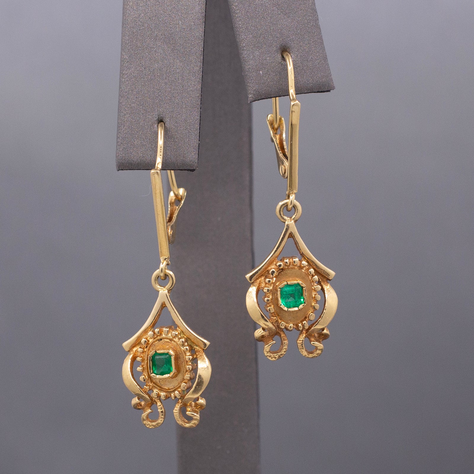 Feminine Bezel Set Emerald Dangle Drop Earrings in 18k Yellow Gold