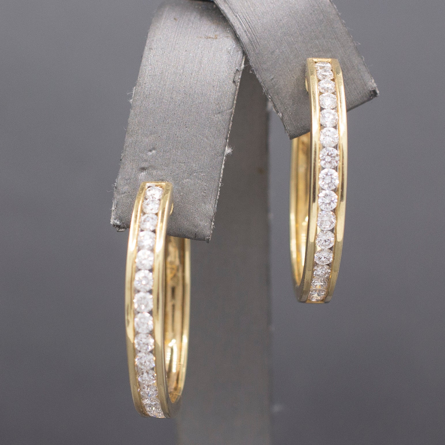 Sparkling Channel Set Diamond Oval Hoop Earrings in 14k Yellow Gold 1.95cttw