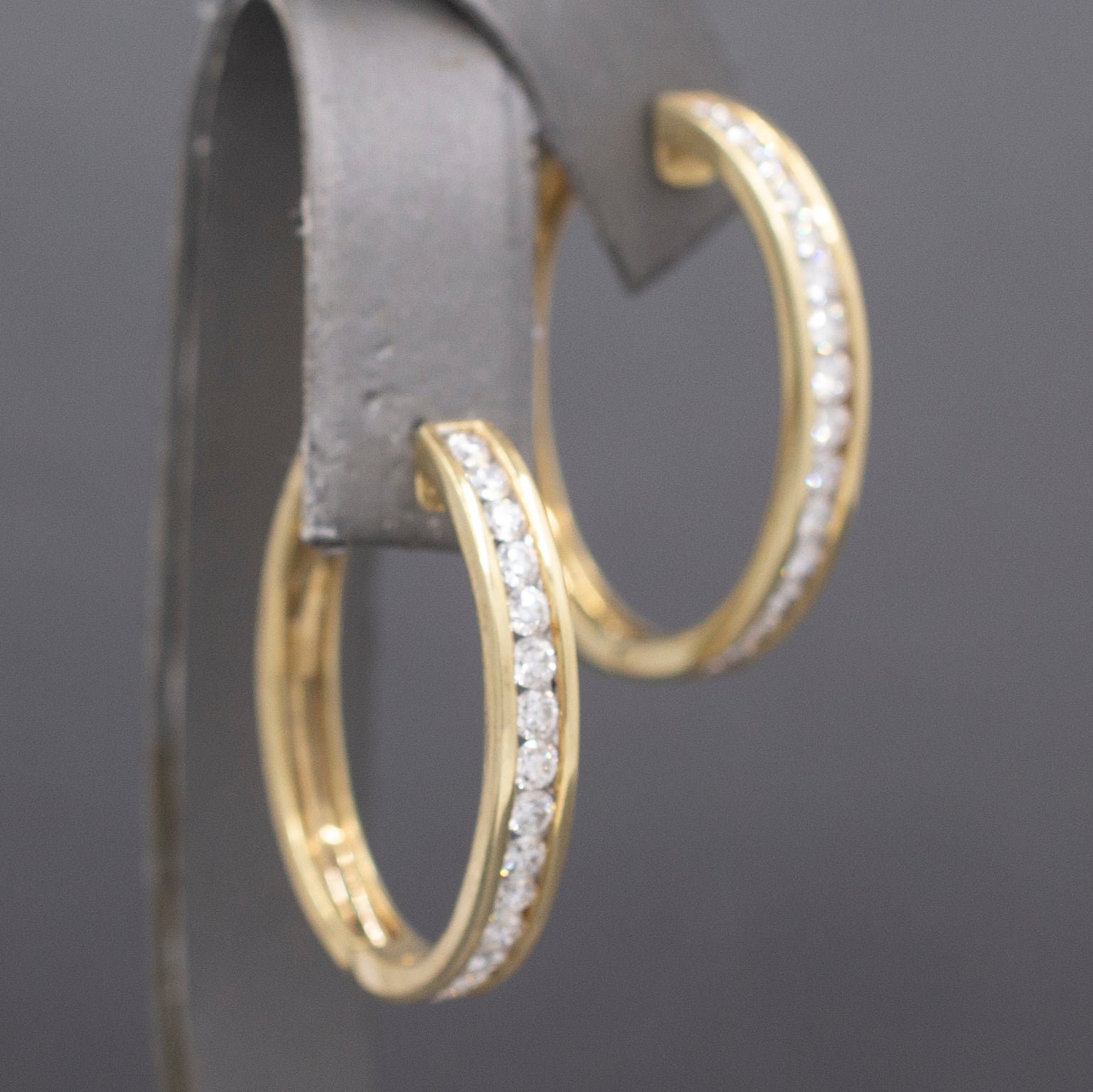 Sparkling Channel Set Diamond Oval Hoop Earrings in 14k Yellow Gold 1.95cttw