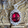 Welcome to true, luxury jewelry.  This is perhaps our most extravagant handcrafted piece to date, featuring a natural cushion shaped rubellite tourmaline from Brazil.  The stone has a red hue with hints of peachy pink depending on the viewing angle.  The stone is untreated and weighs 21.02ct.  We've set it securely with double claw prongs in a diamond-rich Art Deco inspired setting.  The pendant features just under a carat of F/G color, VS2 clarity full cut diamonds, highlighted with layers of piercing and 