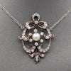 Exquisite Edwardian Natural Pearl and Diamond Bow Necklace in 14k White and Yellow Gold