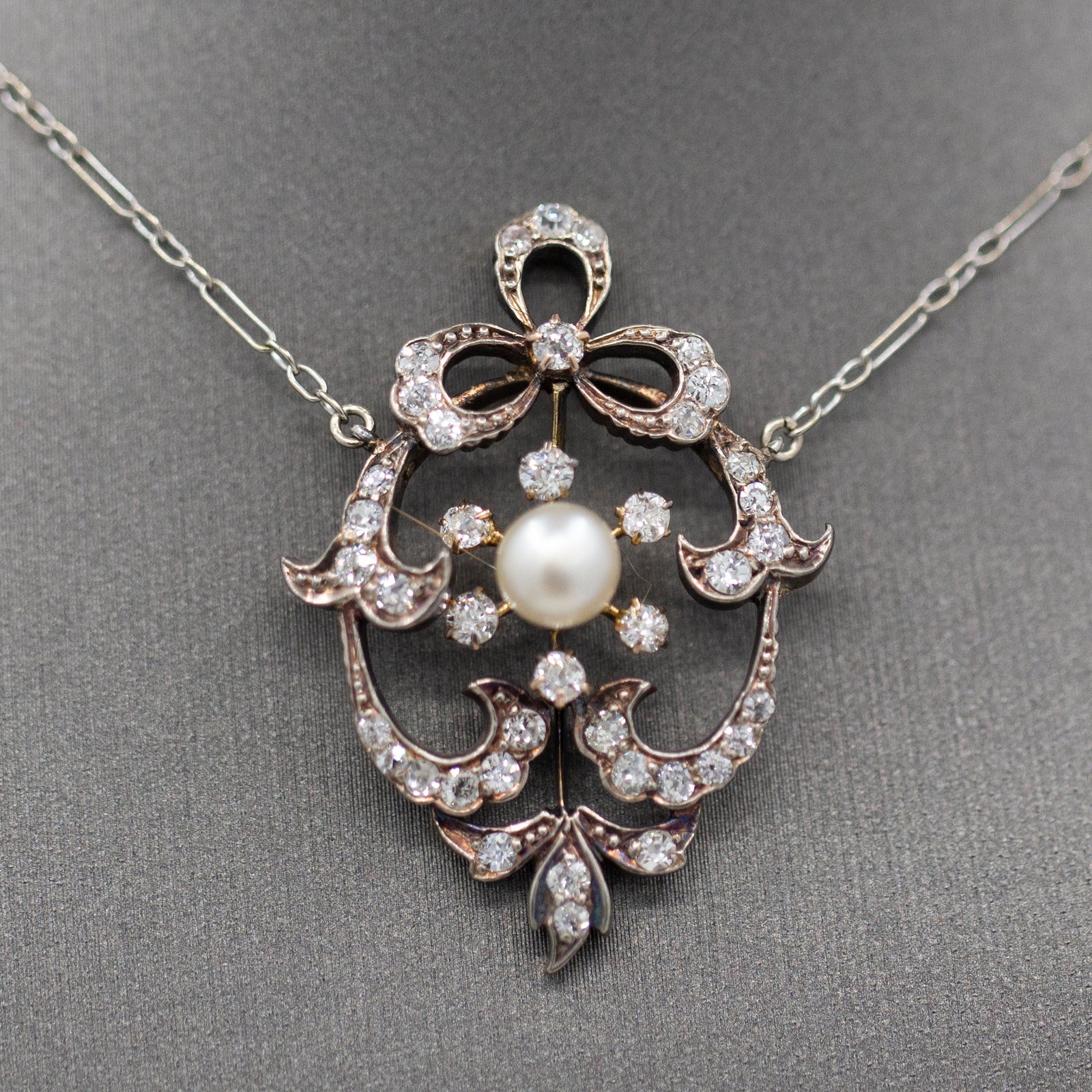 Exquisite Edwardian Natural Pearl and Diamond Bow Necklace in 14k White and Yellow Gold