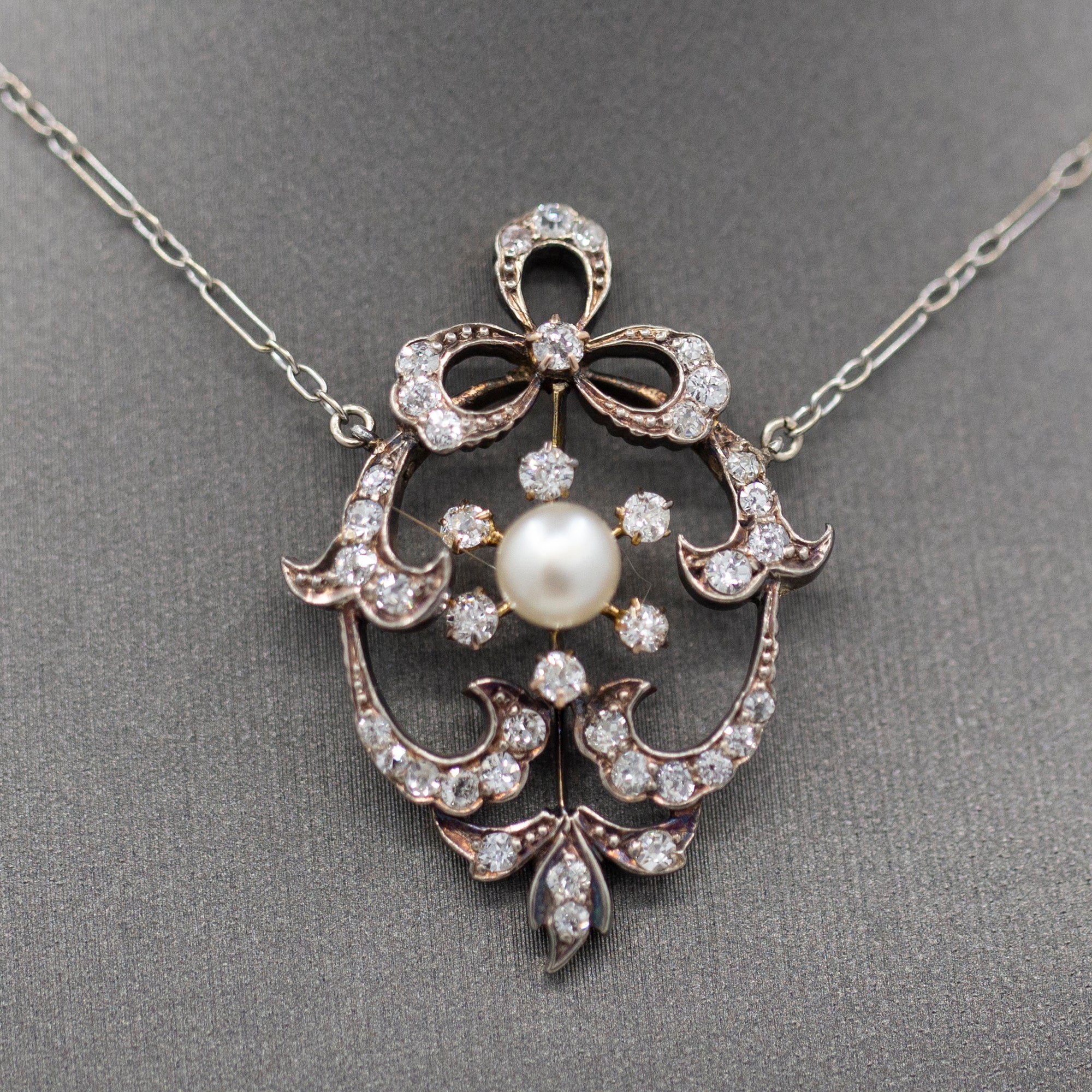 Exquisite Edwardian Natural Pearl and Diamond Bow Necklace in 14k White and Yellow Gold