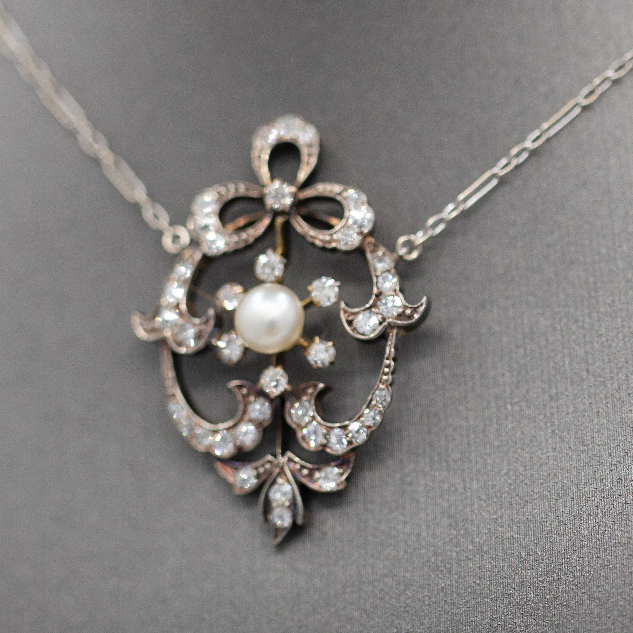 Exquisite Edwardian Natural Pearl and Diamond Bow Necklace in 14k White and Yellow Gold